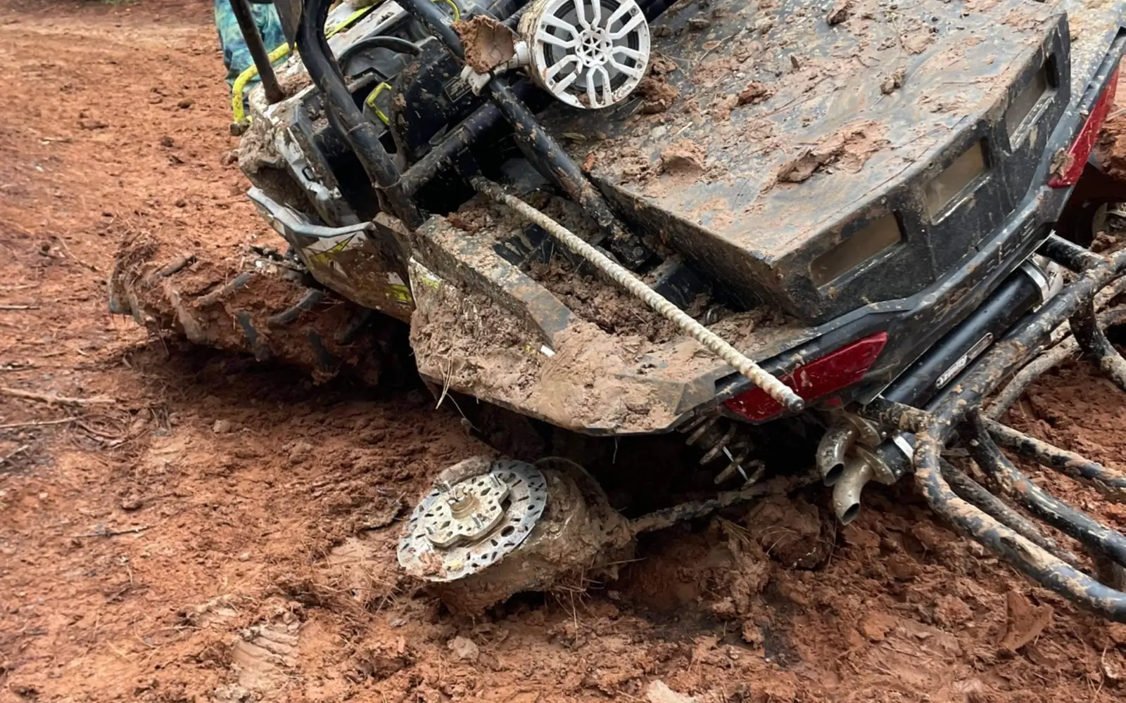 A trail machine using recovery equipment in deep mud